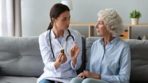 A doctor speaking with an elderly patient about medication