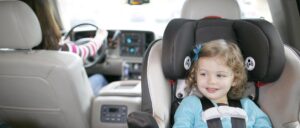 a little girl riding in a rear-facing car seat