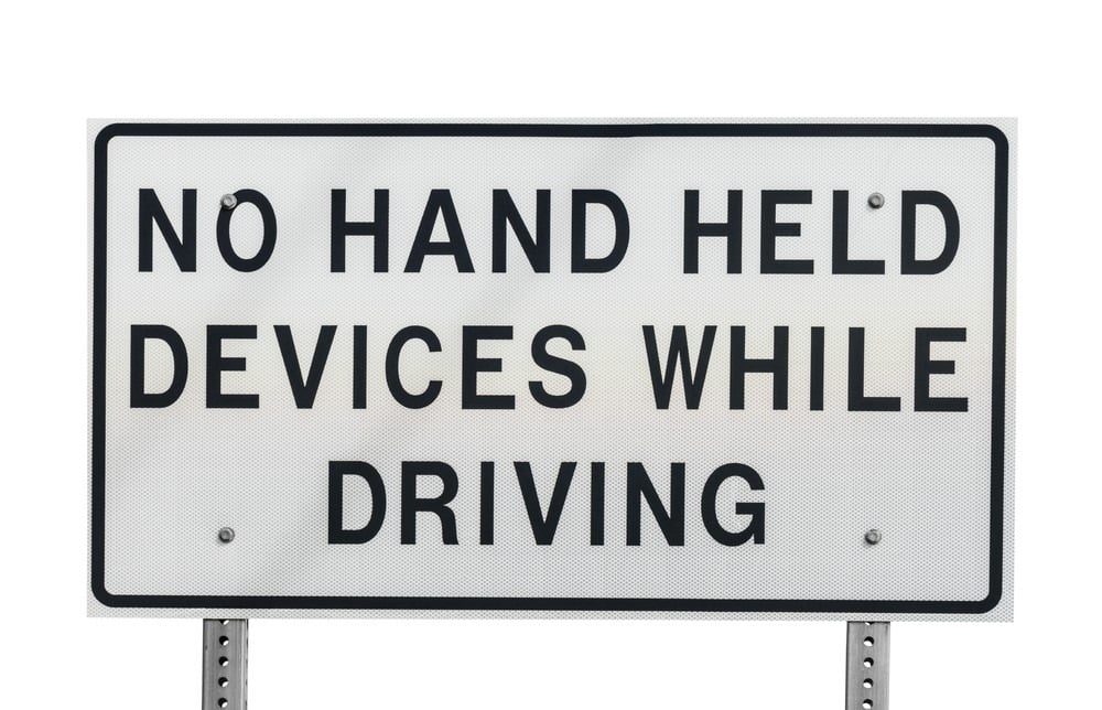 a no hand-held devices while driving sign