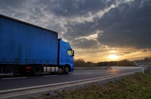 a blue truck on highway at sunrise