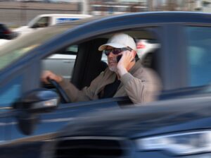A speeding driver talks on his cell phone