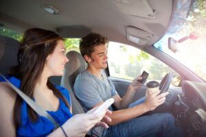 teens on their phones while driving