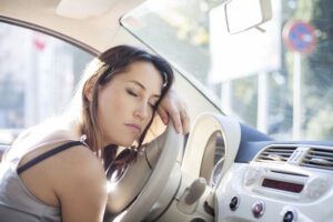 woman car driver asleep at the wheel
