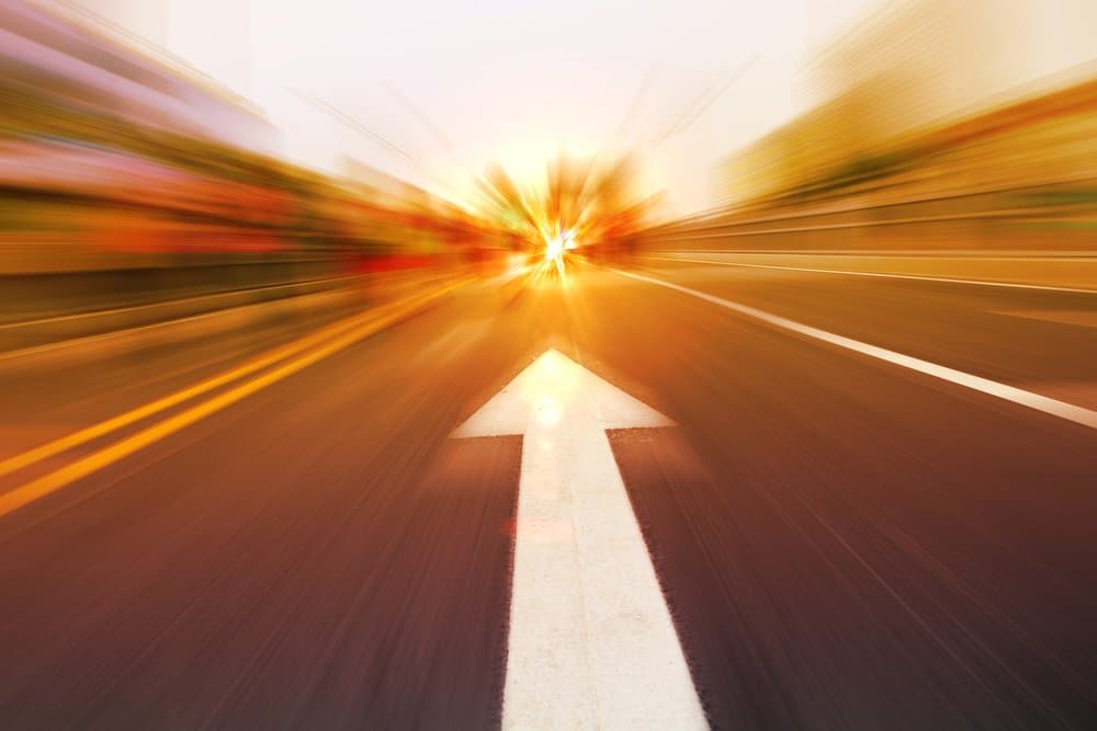 A blurry highway as someone speeds through the passing lane speed limit.