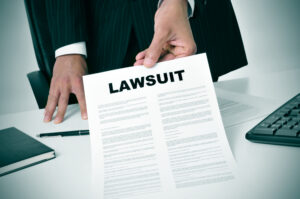 A lawyer in an office reviews and points to a document while explaining a nursing home medication error lawsuit to a client.